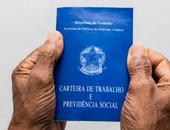 Hands black senior man holding work book brazilian social security document